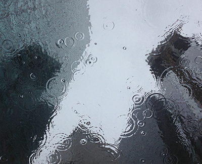 cityscape reflected in puddle