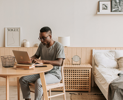 man working in bedroom