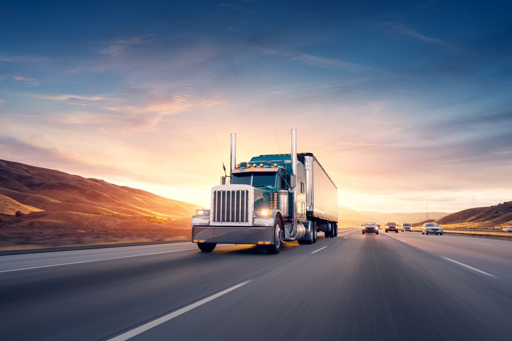 Truck driving on highway with other cars