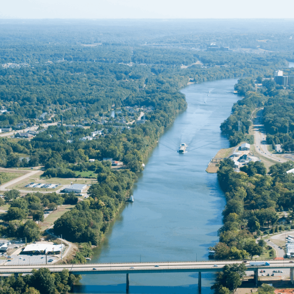 arial view of a river with a boat driving through it